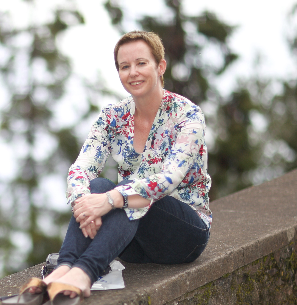 Carol Hickson sitting on a wall